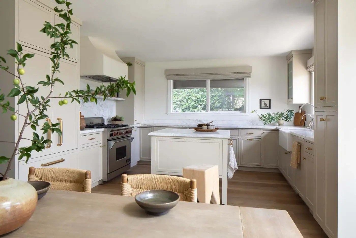 The San Andreas kitchen remodel: putty cabinetry, marble counters and an island under the window