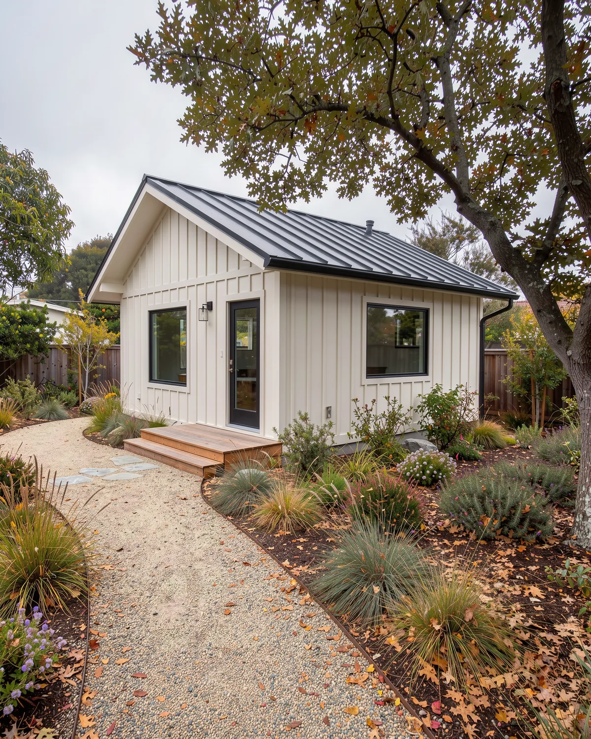 Illustration of a small backyard cottage with board-and-batten siding and a metal roof